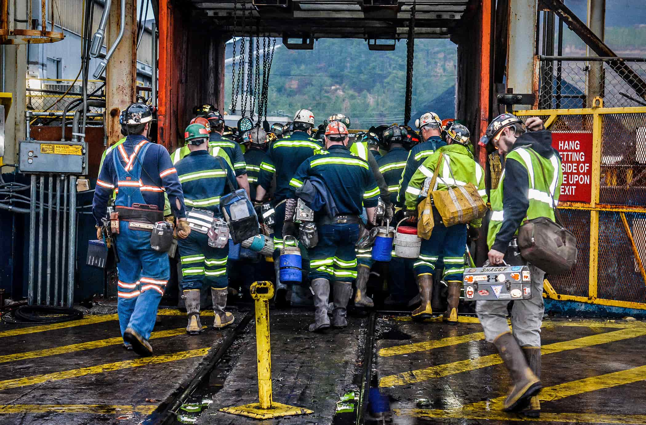 Workers entering the mine elevator