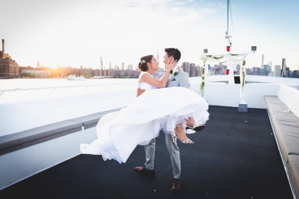 NYC Yacht Wedding with Groom Carrying His Beautiful Bride